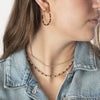 Model wearing 2 gold-filled beaded and garnet gemstone necklaces