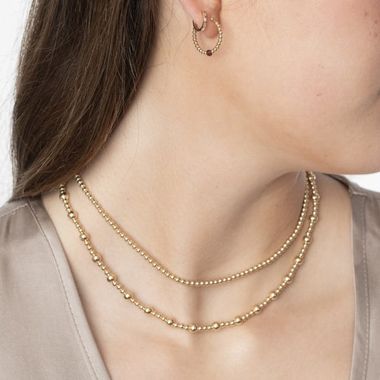 Model wearing 2 gold-filled beaded necklaces
