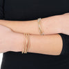 model wearing 3 bracelets on each wrist