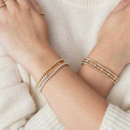 Model wearing mixed metals bracelets and gold filled rings
