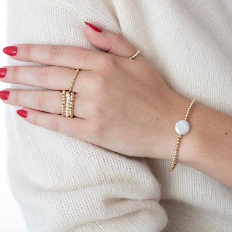 Model wearing gold-filled and pearl rings