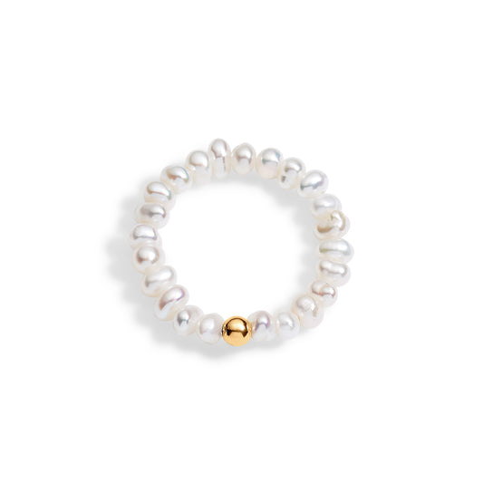 A white pearl stretch ring with a single 3mm 14K gold-filled bead accent, displayed against a white background.