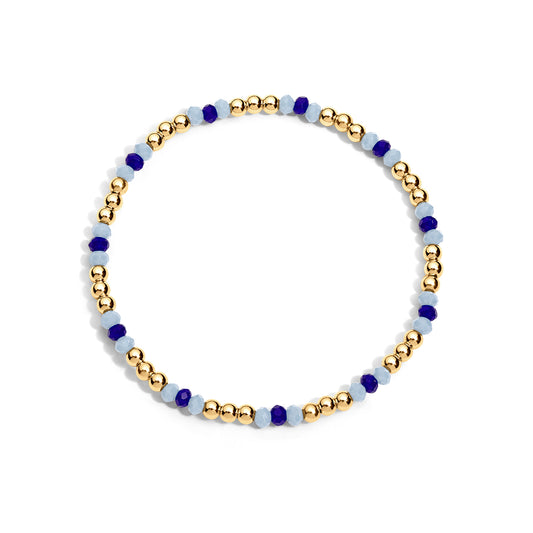 Bracelet with gold, blue, and white beads on a white background