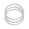A stack of three bracelets, with varying sizes of beads in silver colors, on a white background.