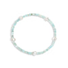 A bracelet with aquamarine gemstones and white pearls, displayed on a white background.