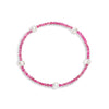 A bracelet with pink gemstones and white pearls, displayed on a white background.