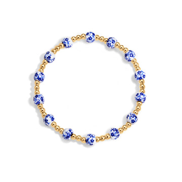 Bracelet with blue and gold beads on a white background