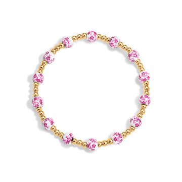 Bracelet with pink beads and gold accents on a white background