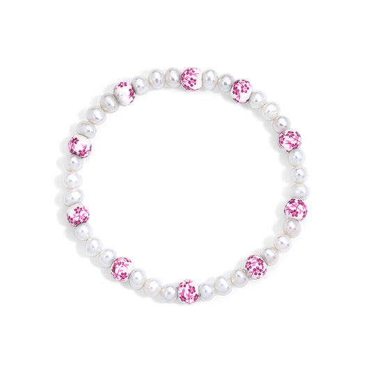 Pearl bracelet with pink gemstones on a white background