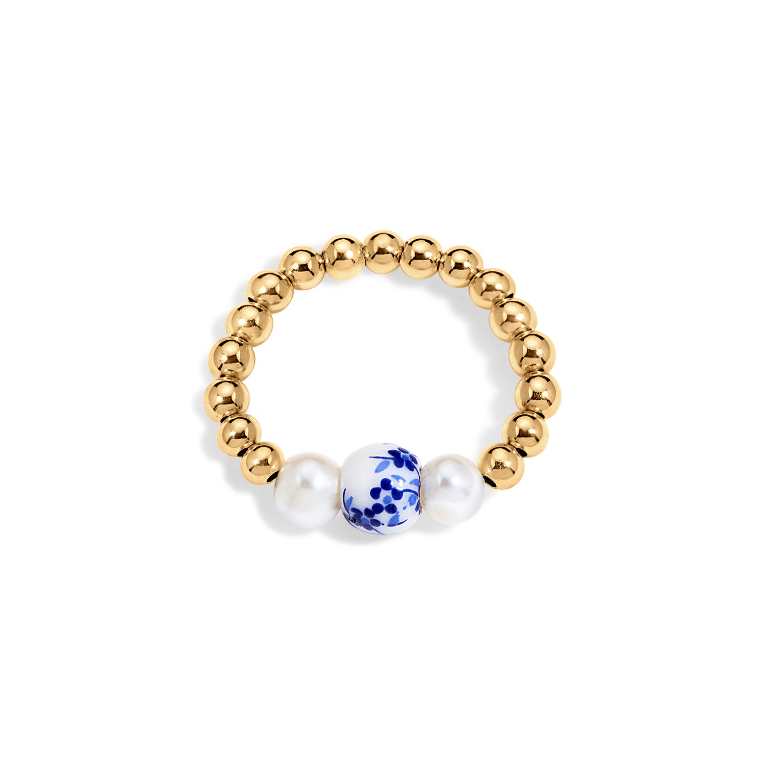 Gold beaded ring with a blue and white ceramic bead and two pearls on a white background