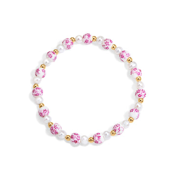 Bracelet with pink and gold beads on a white background