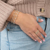 model wearing three bracelets gold filled and sterling silver