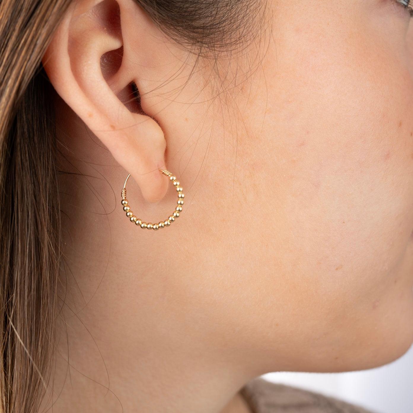 Model wearing gold filled beaded earring