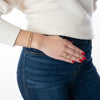 Model wearing gold-filled and gemstone bracelets and rings