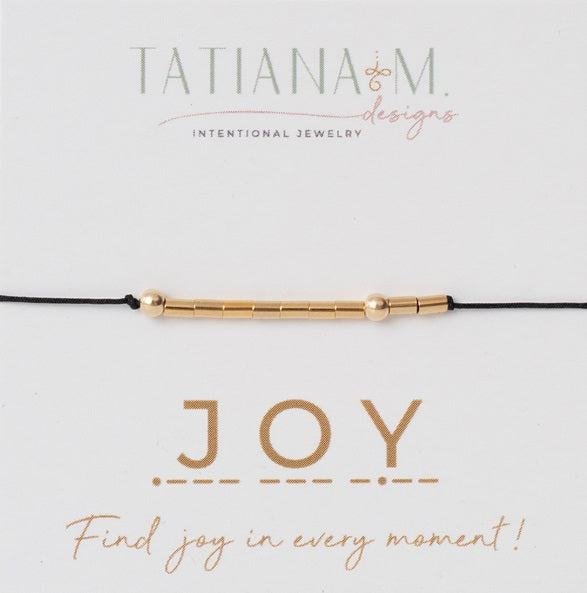 Card with black string and gold filled beaded bracelet saying Joy