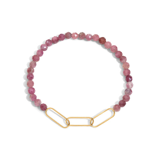 A bracelet with pink gemstone beads and a gold-filled paperclip accent.