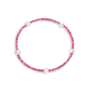 A bracelet with pink gemstones and white pearls, displayed on a white background.
