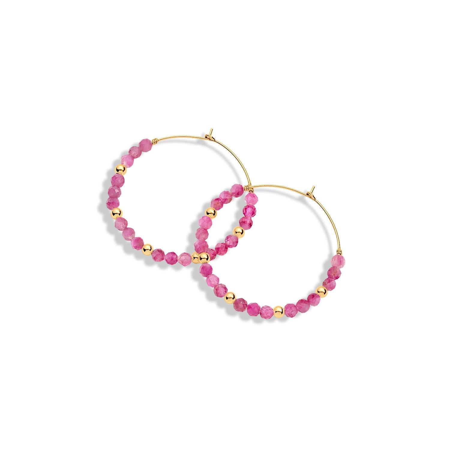 A pair of gold-filled hoop earrings with pink gemstones and gold beads
