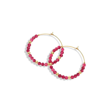 A pair of gold-filled hoop earrings with ruby gemstones and gold beads