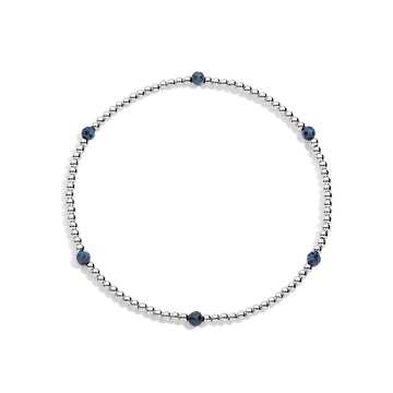 A sterling silver bracelet with blue gemstone accents on a white background.