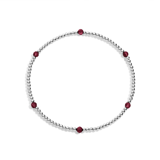 A sterling silver bracelet with garnet gemstone accents on a white background.