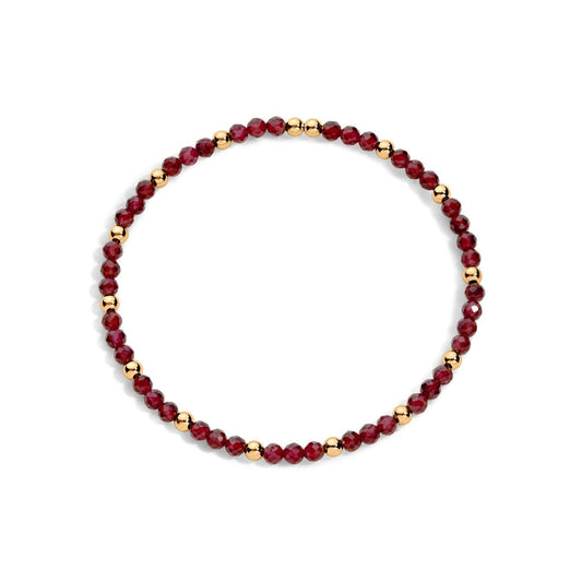 A bracelet with garnet gemstones and gold-filled beads, displayed against a white background.