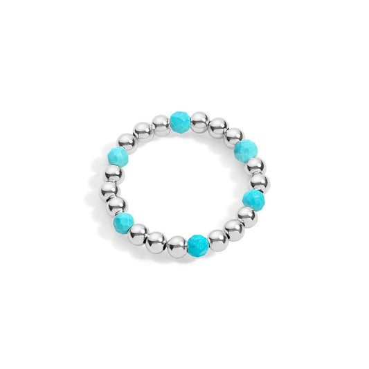 A sterling silver ring with turquoise gemstone accents, featuring a stretchable design with silver beads and purple stones evenly spaced around the band.