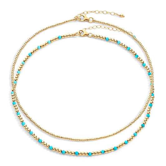 Two-layered gold-colored necklace with turquoise semi-precious gemstones and 14k gold-filled beads, displayed against a white background.