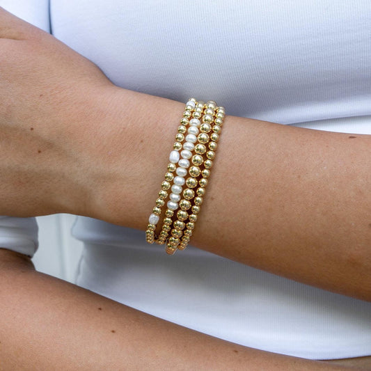 Model wearing gold filled beaded bracelet with pearls