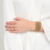 model wearing gold filled beaded bracelet and rings